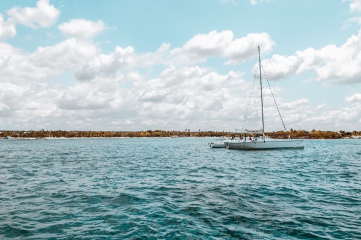 Sailboat on a calm sea under a partly cloudy sky.